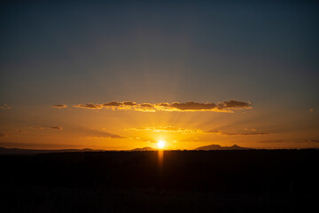 Sunset sky dramatic sunset clouds and sunset sunrays. Dramatic sky with clouds at sunset or sunrise. Sunrays. Skyscape nature composition. Natural sky background. Panorama scenic of the sunrise.