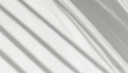 Obraz premium Soft light rays streaming across a smooth white surface, creating a serene and abstract background perfect for design, presentations, or creative projects. 