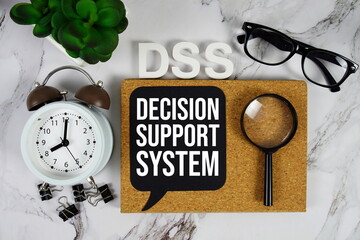 DSS - Decision Support System acronym with alarm clock and magnifying glass, business concept background