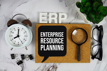ERP - Enterprise Resource Planning acronym with alarm clock and magnifying glass, business concept background