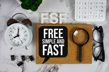 FSF - Free Simple and Fast acronym with calculator, alarm clock and magnifying glass, Business and Financial concept background