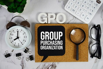 GPO - Group Purchasing Organization acronym with calculator, alarm clock and magnifying glass, Business and Financial concept background