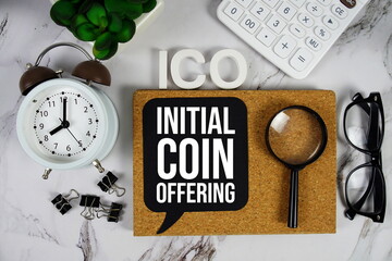 ICO - Initial Coin Offering acronym with calculator, alarm clock and magnifying glass, Business and...