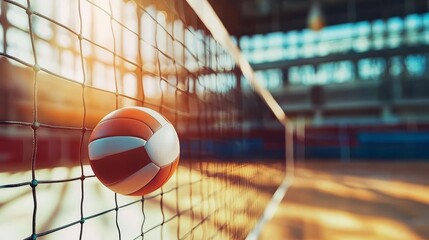 A dynamic volleyball in mid-air near the net, showcasing the energy and excitement of indoor sports in a vibrant gym environment.