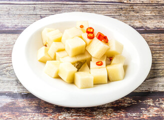 Sichuan pickled radish served in plate isolated on wooden table side view of hong kong food