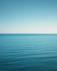 Obraz premium A serene view of calm ocean waters under a clear blue sky.