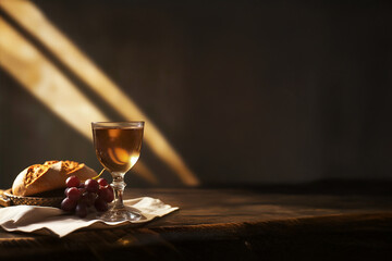 Pain et calice doré sous une lumière divine, symbole de l'Eucharistie et de la communion chrétienne, espace négatif copyspace. Pâques, mort du Christ