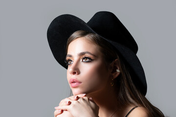Sensual fashion woman face close up. Beauty portrait of young sexy woman in black hat. Elegant Lady.