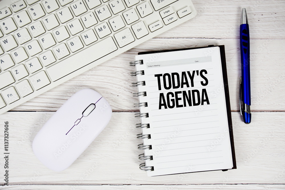 Poster today's agenda text on notepad with keyboard and optical mouse on wooden background