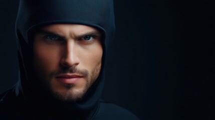 A man with a hooded sweatshirt and a beard