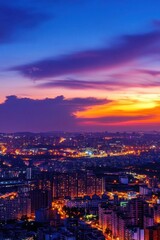 Fototapeta premium A vibrant sunset over a city skyline, showcasing urban lights and clouds.
