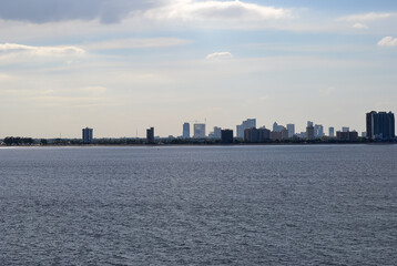 Fototapeta premium landscape with the calm Sea, with the city visible on the horizon