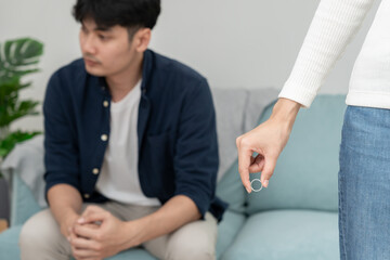 Obraz premium Divorce. Woman remove married ring. Couples desperate and disappointed after marriage. Husband wife sad, upset and frustrated after quarrels conflict. distrust, love problems, betrayals, family, lover