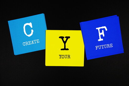 CYF - Create Your Future acronym text on sticky note on black background