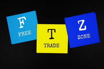 FTZ - Free Trade Zone acronym text on sticky note on black background