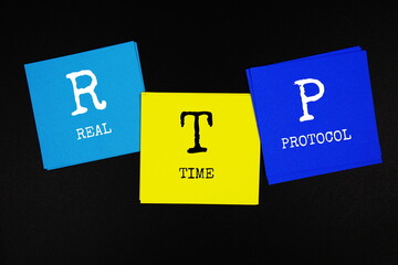 RTP - Real Time Protocol acronym text on sticky note on black background