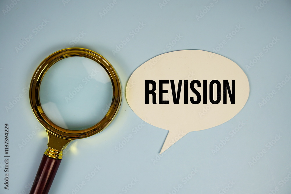 Poster revision text on speech bluble with magnifying glass top view on blue background