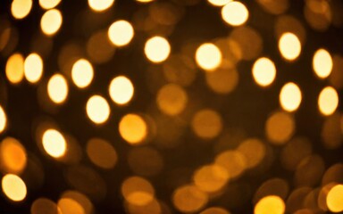 Fototapeta premium A blurred background of warm, golden bokeh lights creating a festive atmosphere.