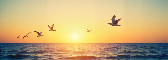 Fototapeta premium Seagulls Flying Over Ocean at Golden Sunset