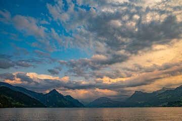 Mountain in the Alps in summer, panoramic view with mountain. Switzerland Alps nature and travel. Alpine scenery. Mountain with lake in Alps. Summer view over the lake and the alps in Switzerland.