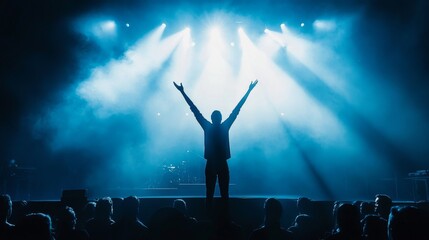 triumphant figure backlit, arms raised victory pose, glowing stage spotlight, dark audience foreground, atmospheric blue lighting, professional event scene, powerful celebration moment