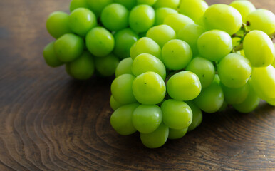 white (green) grapes on a wooden table. Grape Clusters from autumn Vineyard.  Organic, Ripe, and Ready .Harvest season.