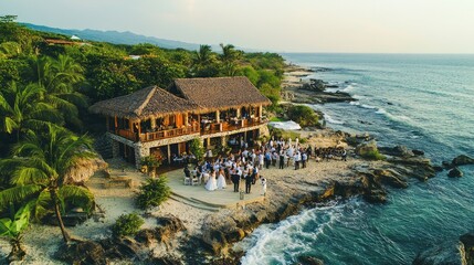 Bride and groom dancing at tropical beach wedding reception with guests celebrating near ocean