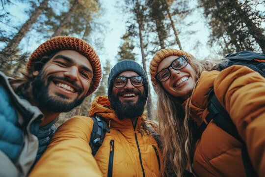 Hikers smiling and taking selfie in forest during sunny day - Powered by Adobe