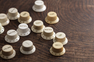 Tone knob, Volume knob. Electric Guitar knobs, Various electric guitar knobs on s old wooden work...