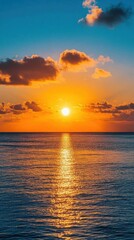 Fototapeta premium A serene sunset over the ocean, casting warm reflections on the water.