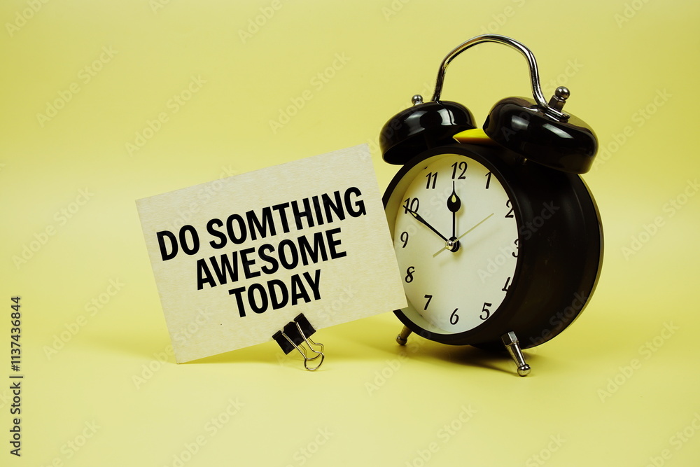 Poster do somthing awesome today text message on paper card with alarm clock on yellow background