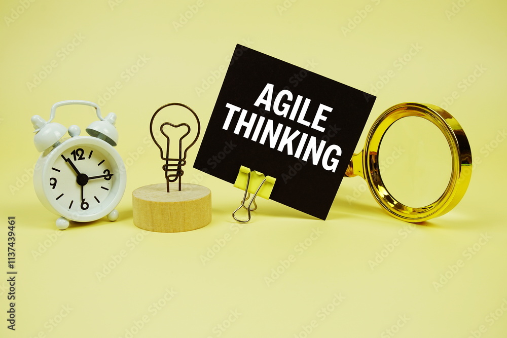 Poster agile thinking text message on sticky note with magnifying glass and alarm clock on yellow backgroun