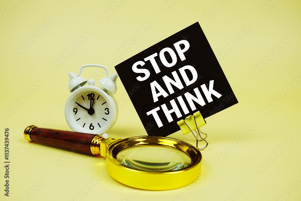 Poster stop and think text message on sticky note with magnifying glass and alarm clock on yellow backgroun