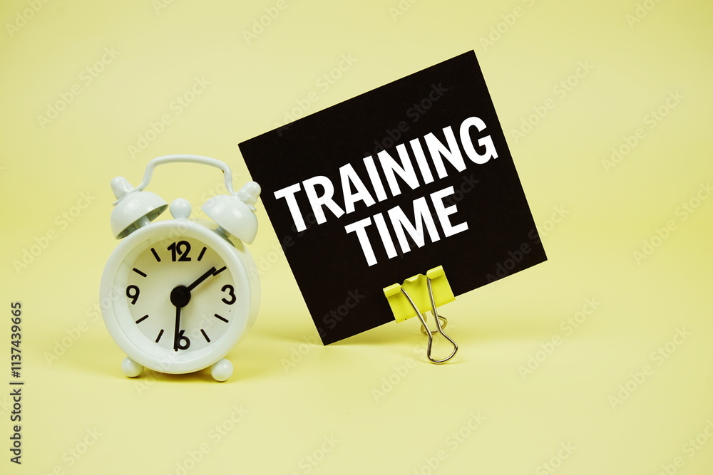 Poster training time text message on paper card with alarm clcok on yellow background