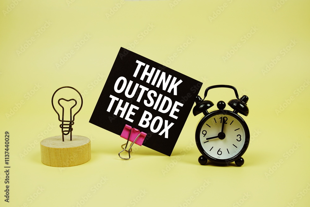 Poster think outside the box text message on paper card with alarm clcok on yellow background