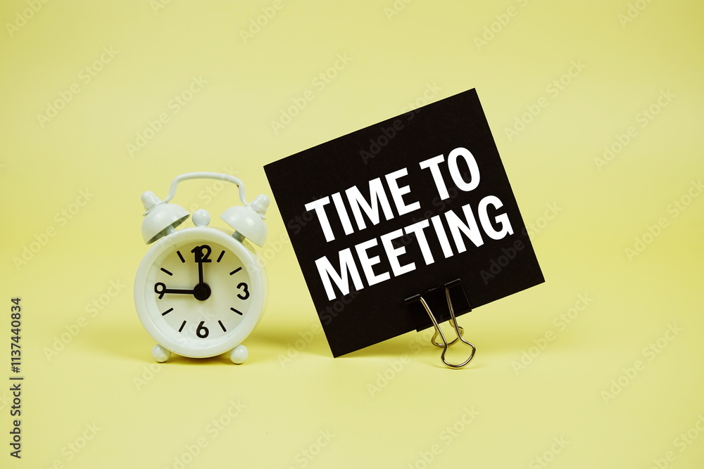 Poster time to meeting text message on paper card with alarm clcok on yellow background