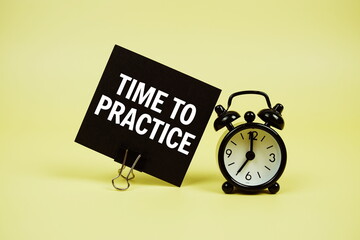 Time to Practice text message on paper card with alarm clcok on yellow background - obrazy, fototapety, plakaty