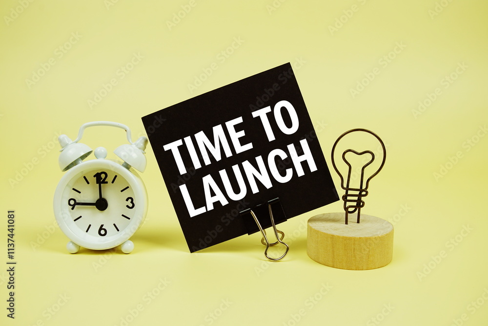 Poster time to launch text message on paper card with alarm clcok on yellow background
