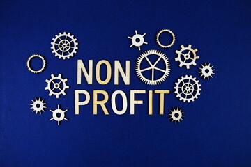 Non Profit alphabet letters with gears element on navy blue background