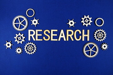Research alphabet letters with gears element on navy blue background