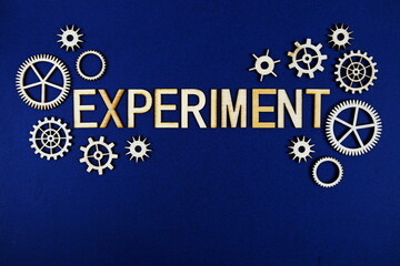 Experiment alphabet letters with gears element on navy blue background