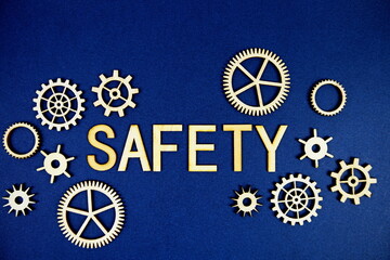 Safety alphabet letters with gears element on navy blue background