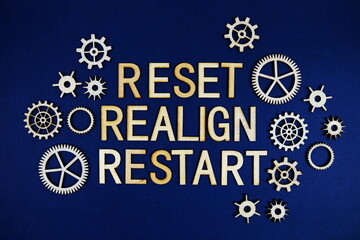 Reset Relign Restart alphabet letters with gears element on navy blue background