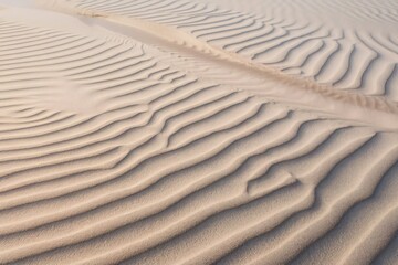 Obraz premium a sandy surface, with the sand being a light beige color.