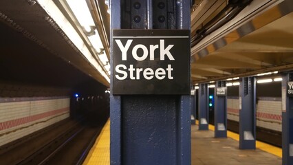 New York City empty subway station interior, underground metropolitan platform sign. Metro railway passenger public transport, United States. Perspective. Text signboard York Street. Brooklyn Downtown