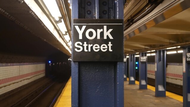 New York City empty subway station interior, underground metropolitan platform sign. Metro railway passenger public transport, United States. Perspective. Text signboard York Street. Brooklyn Downtown