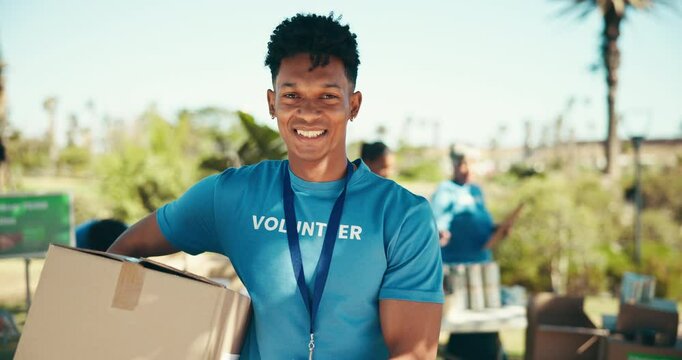 Outdoor, man and face with box for volunteering, community service and distribution for charity project. Park, male coordinator and portrait with food for donation, package and social responsibility