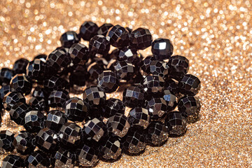 Beautiful faceted beads of black spinel in macro photography, perfect for crafting and jewelry design. Decorative round stone beads of black color for boho jewelry design.