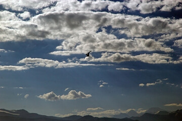 Clouds over the mountains along the shore of Karakul Lake in the Pamir Mountains in Tajikistan