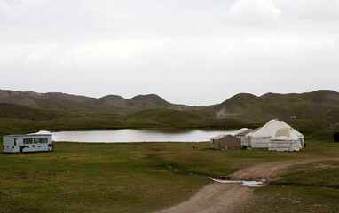 Yurt camp at Tulpar Kul Lake at the foot of Lenin Peak in the Pamir Mountains in Kyrgyzstan